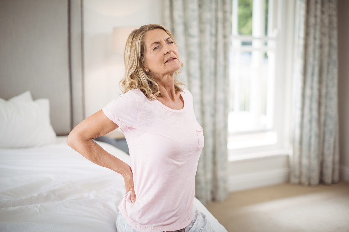 Older woman experiencing lower back pain