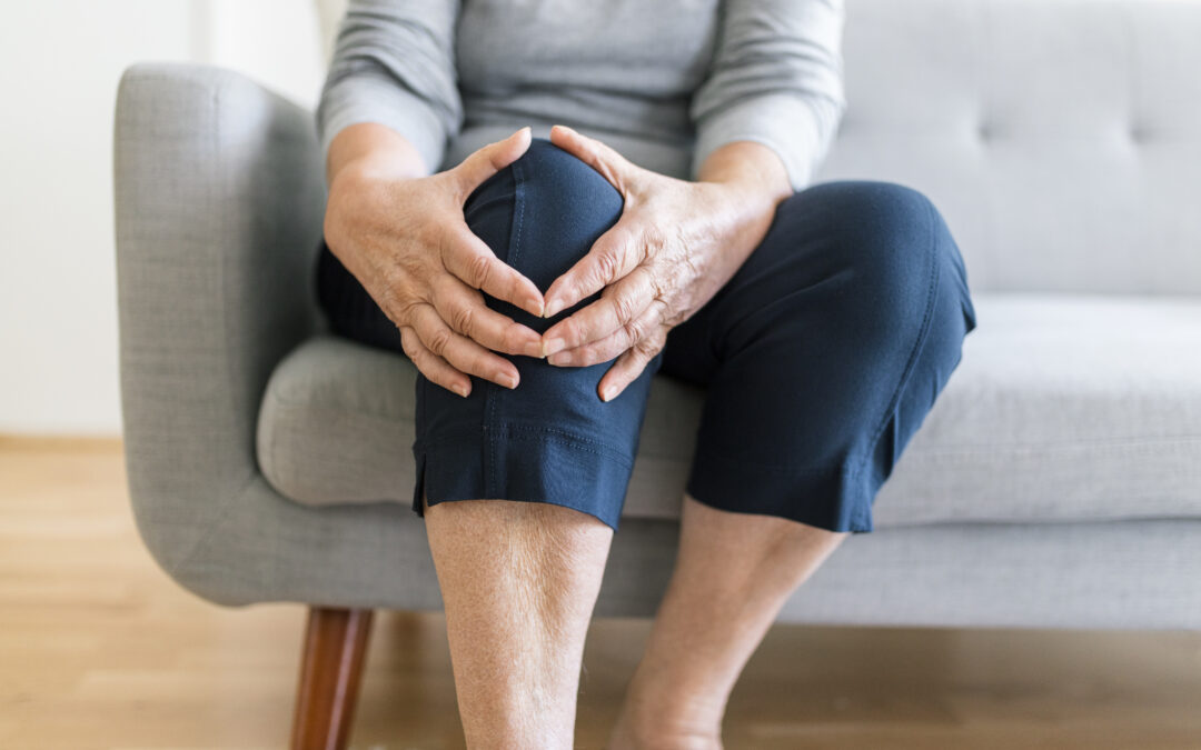 woman holding knee pain