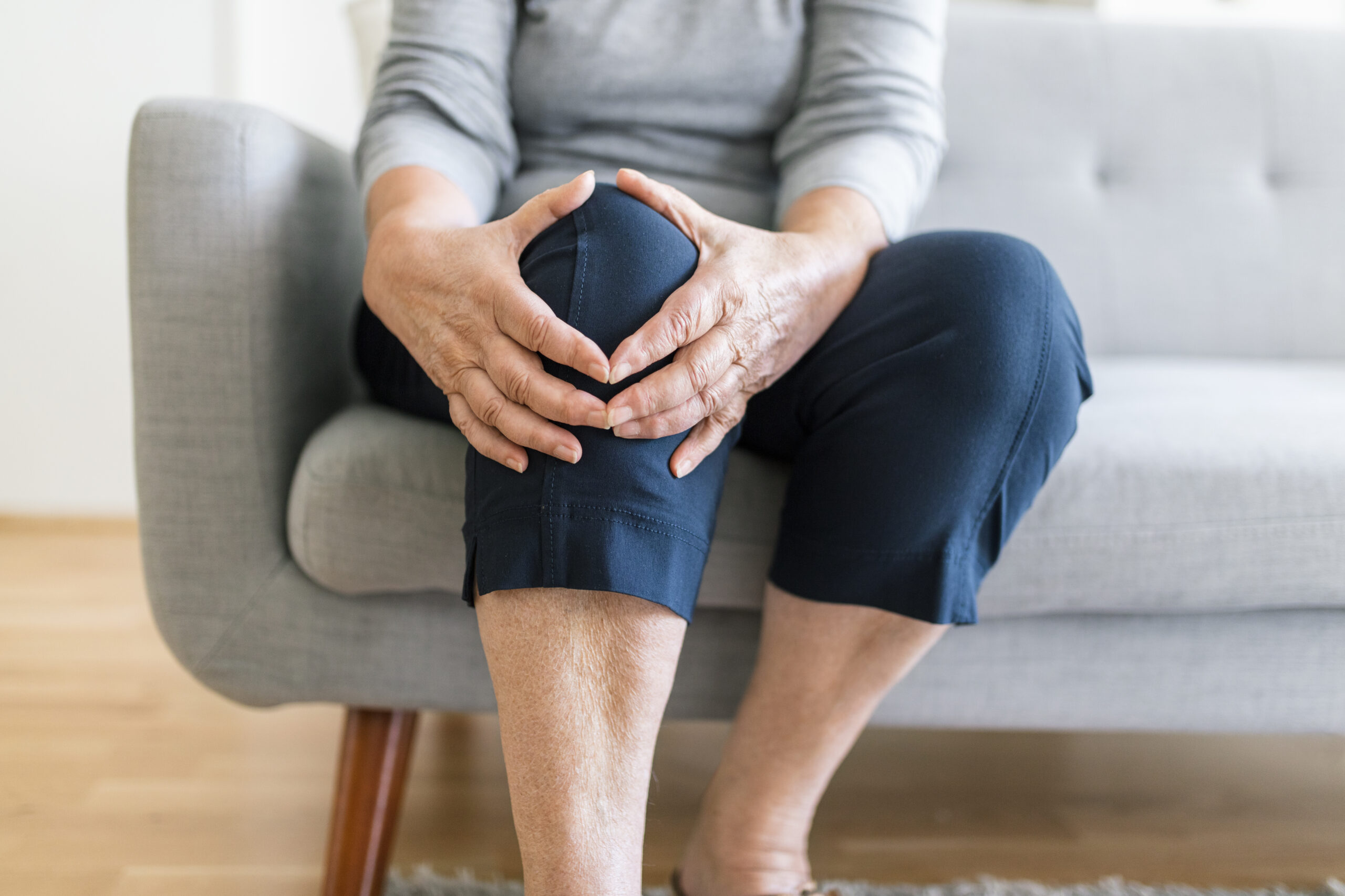 woman holding knee pain