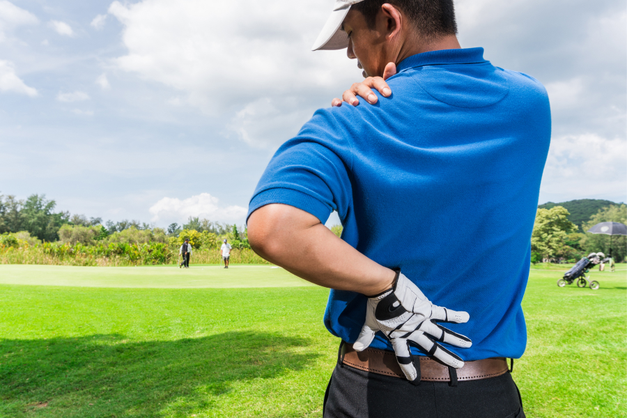 Orthopedic Injuries & Trauma - Golfer holding his back in pain