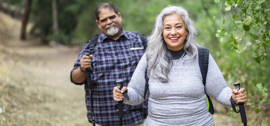 A senior couple hiking in the woods
