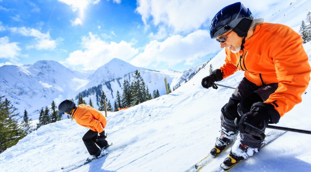 Man skiing with his kids