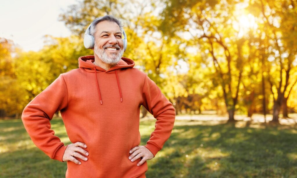 Man happily running in park