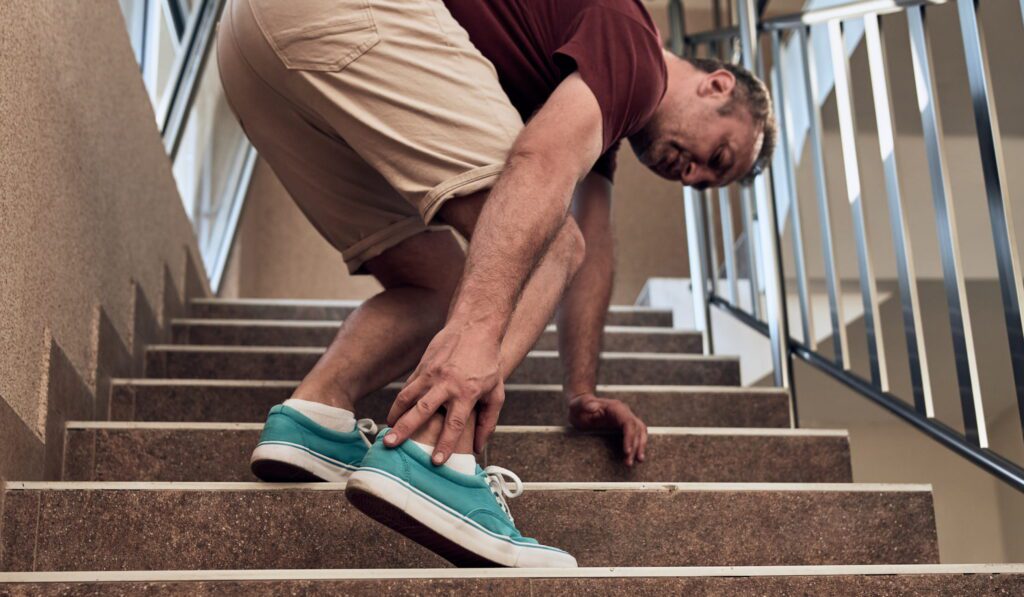 Man ascending stairs with ankle pain